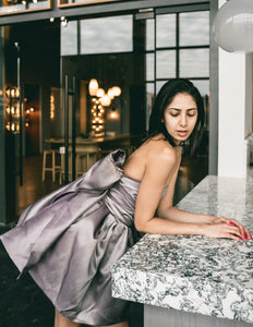 House Of KLynn Love The Chase couture dress exquisite couturier artisan, lavender purple strapless wrap around oversized back bow flows down to hem of short flouncy dress, fun silhouette highlighting all your curves to perfection Instantly becoming a wardrobe favorite